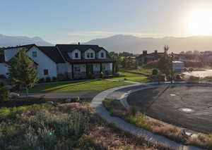 Exterior space with a mountain view and a lawn