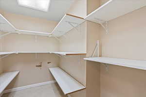 Walk in closet featuring light tile patterned flooring