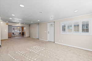 Unfurnished living room featuring light carpet