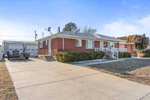 Single story home with a garage and an outdoor structure