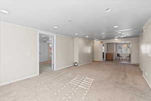 Carpeted empty room with ornamental molding