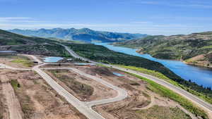 Drone / aerial view featuring a water and mountain view