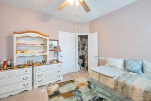 Carpeted bedroom with ceiling fan