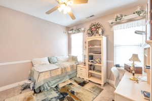 Bedroom with light carpet and ceiling fan