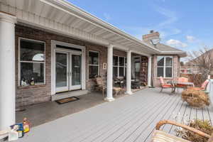 Wooden terrace featuring french doors