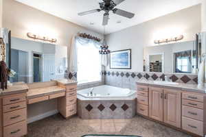 Bathroom with independent shower and bath, vanity, tile patterned floors, and ceiling fan