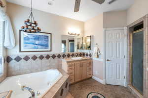 Bathroom with vanity, shower with separate bathtub, and ceiling fan