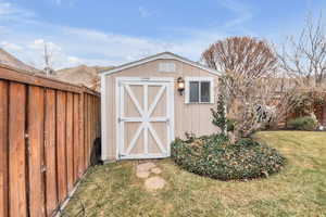 View of outbuilding with a mountain view and a lawn