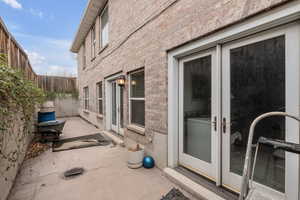 View of home's exterior with french doors and a patio area