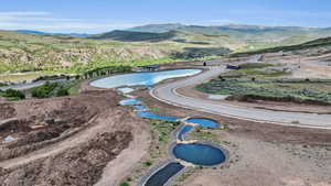 Drone / aerial view featuring a water and mountain view