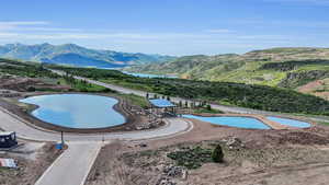 View of swimming pool with a water and mountain view