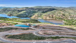 Birds eye view of property with a water and mountain view