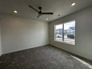 Carpeted spare room with ceiling fan and a textured ceiling