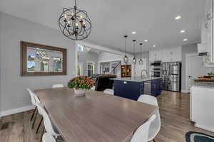 Dining room with LVP flooring, and a chandelier