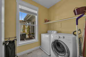 Clothes washing area featuring independent washer and dryer