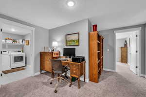 Basement MIL apartment hallway (large enough for a desk) featuring light carpet