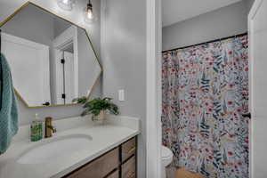 Bathroom featuring vanity, toilet, and tub/shower combo