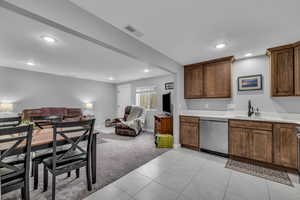 Basement MIL apartment featuring light carpet and tile