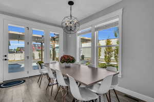 Dining room with LVP floors and a chandelier