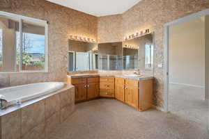 Bathroom with vanity and independent shower and bath