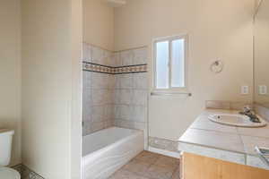 Bathroom with tile patterned floors, vanity, and toilet