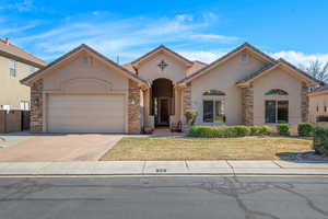 View of front of house featuring a garage and a front yard