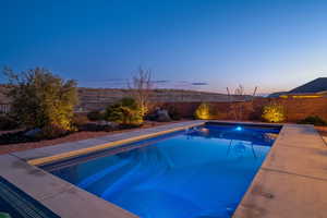 View of pool at dusk