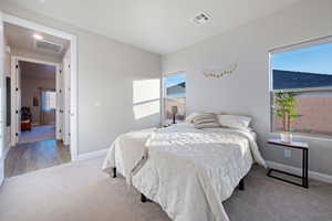 Bedroom featuring light colored carpet