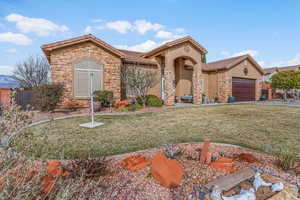 View of front of property with a front lawn and a garage