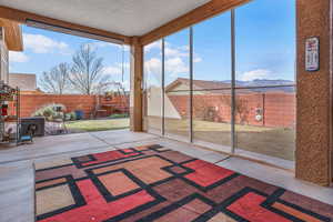 Unfurnished sunroom with a mountain view and a wealth of natural light