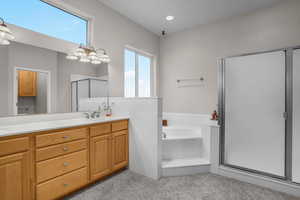 Bathroom with vanity, plenty of natural light, shower with separate bathtub