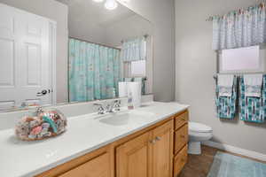 Bathroom with tile patterned flooring, vanity, and toilet