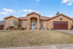 View of front of home featuring a front lawn and a garage