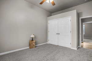 Unfurnished bedroom featuring a closet, ceiling fan, and carpet