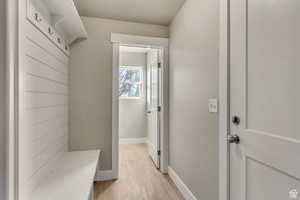 Mudroom with light hardwood / wood-style floors