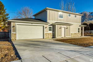 Front of property with a garage and a mountain view