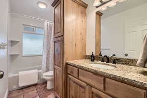 Full bathroom featuring vanity, tile patterned floors, toilet, and shower / bath combo