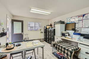 Office area featuring a textured ceiling