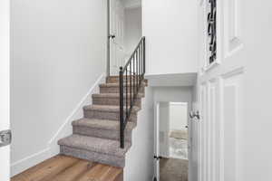 Staircase with hardwood / wood-style floors