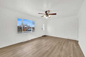 Spare room with ceiling fan and light wood-type flooring