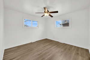 Empty room featuring wood-type flooring and ceiling fan