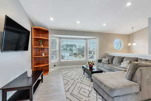 Living room featuring a chandelier and light wood LVP-type flooring