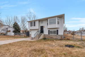 Raised ranch with a garage and a front yard