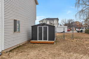 View of yard featuring a storage unit