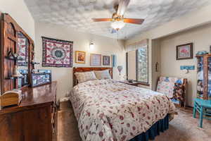 Bedroom with ceiling fan and carpet flooring