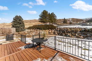 Snow covered deck with a mountain view