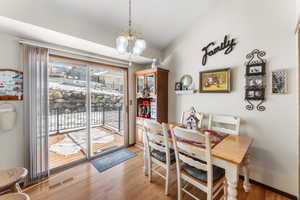 Dining room featuring light hardwood / wood-style floors and a chandelier