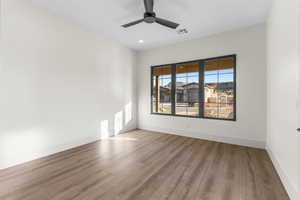 Empty room featuring ceiling fan and light hardwood / wood-style floors