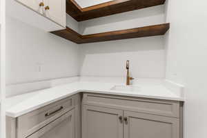 Interior space with gray cabinetry and sink