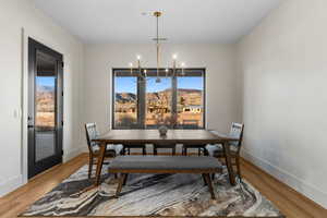 Dining room featuring an inviting chandelier, wood-type flooring, and a mountain view